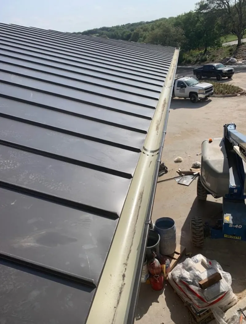 Standing seam panel and gutter detail on a metal roofing jobsite in Windsor